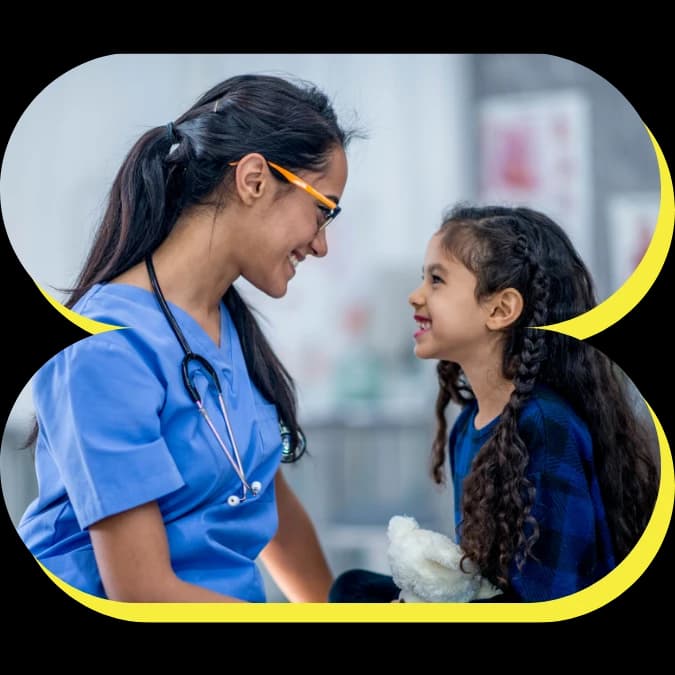 A physician comforting a young patient